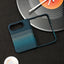 A dark blue and teal striped phone case with a textured pattern, displayed on a dark textured surface next to a vinyl record prop.