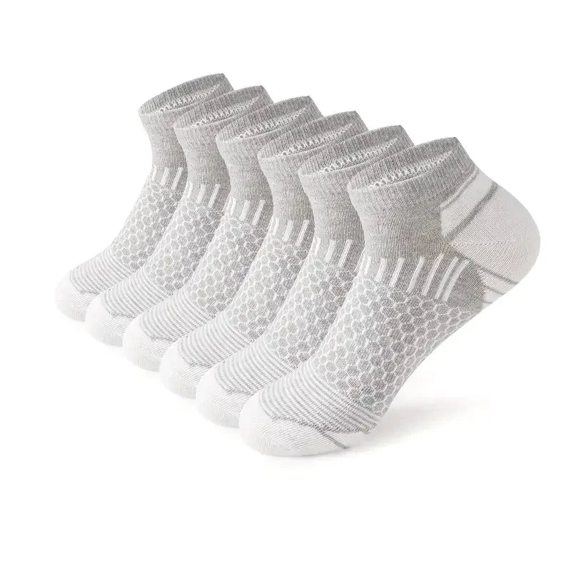 6 pairs of solid white mens low tube athletic socks made of soft sweat wicking fabric