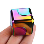 metal fidget spinner cube held in hand showing rainbow iridescent finish for tactile stress relief