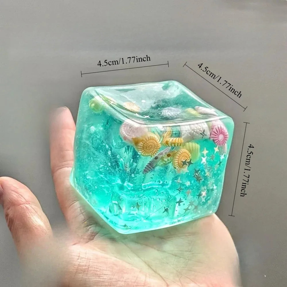 clear translucent squishy stress balls cube showing miniature sea turtle inside for desktop focus