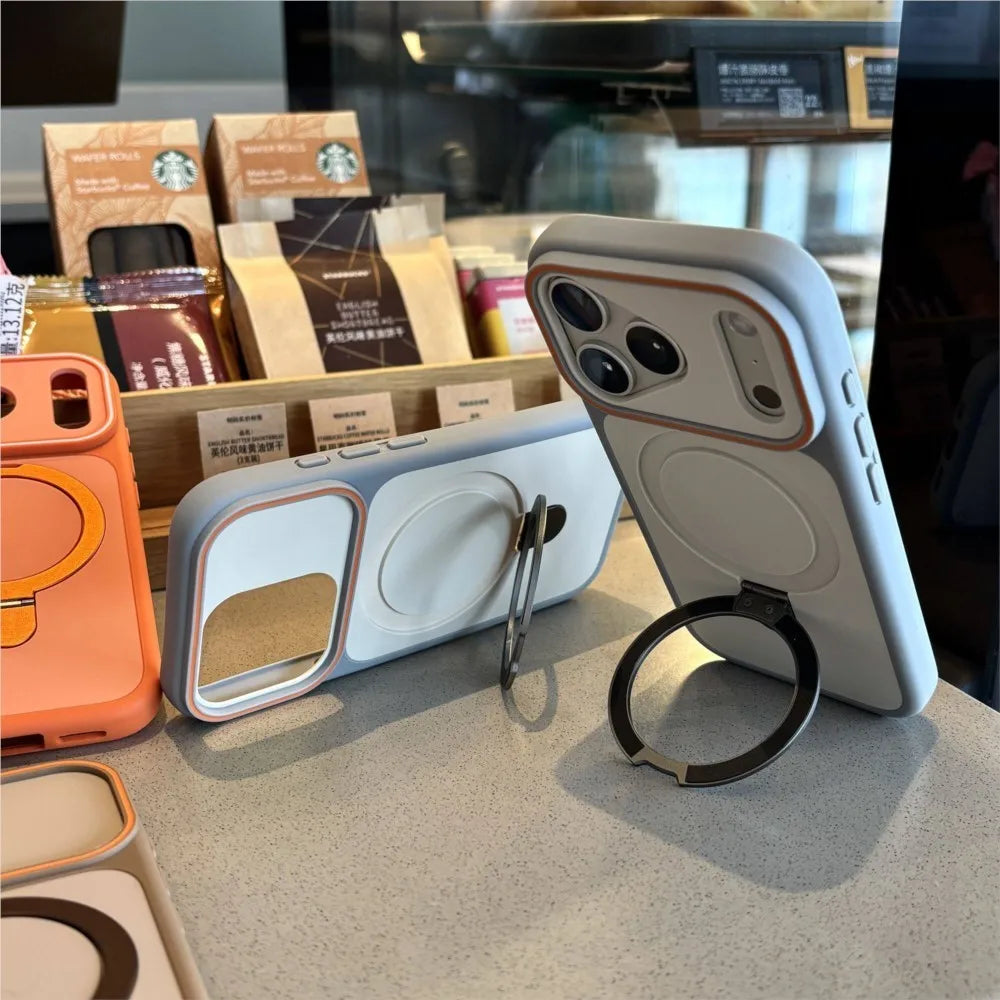 Phone cases with ring stands on a surface, with Starbucks products in the background.