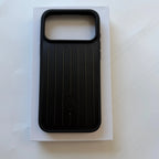 A black protective phone case with a vertical ribbed texture and a large camera cutout, displayed on top of its white packaging box against a light background.