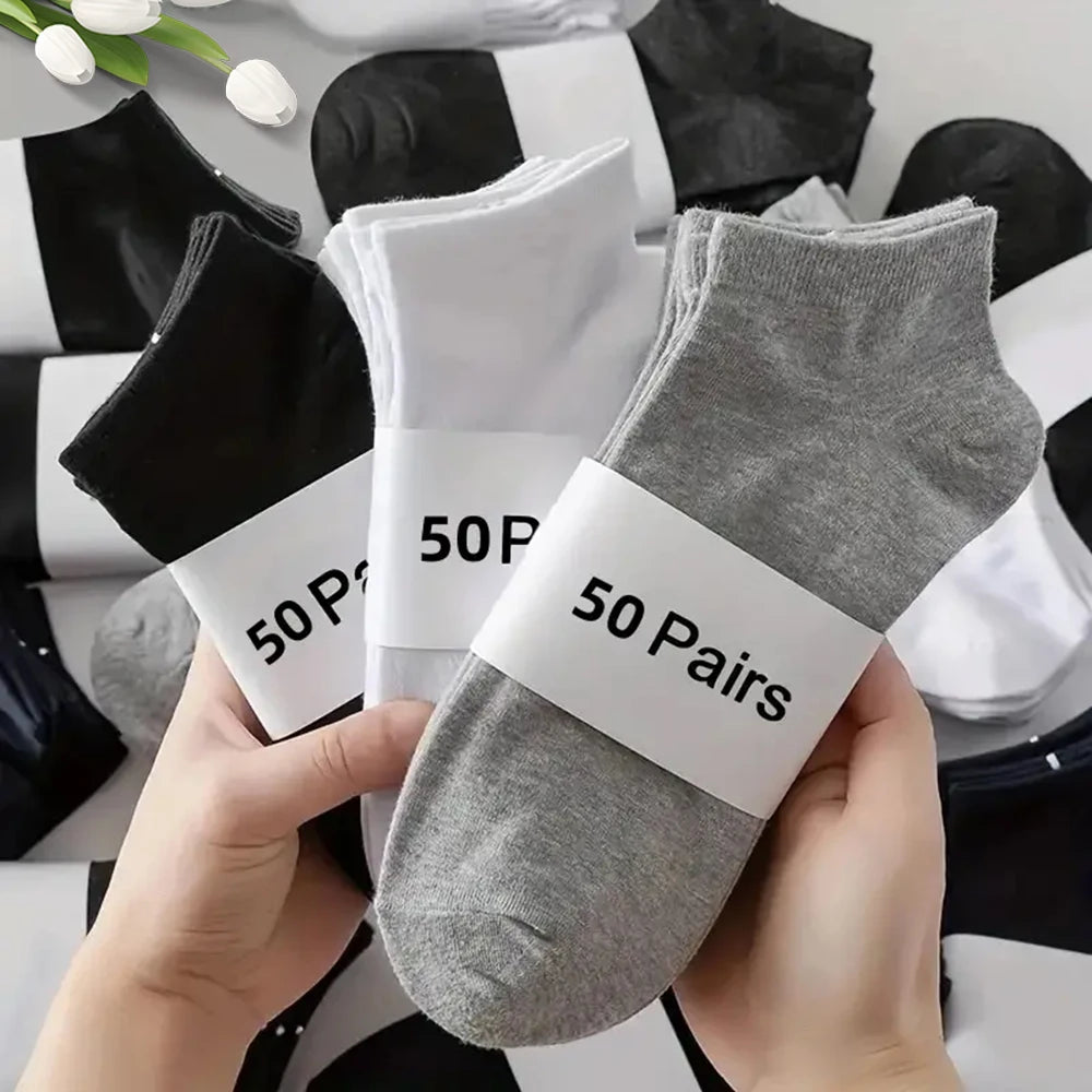 Multipack of men's breathable deodorant low cut ankle socks in black white and grey colors with sweat wicking fabric