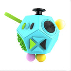 Colorful fidget cube toy with various textured sides on a white background