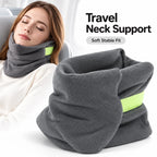 A gray fleece travel neck support pillow with a bright lime green accent band, shown both folded on a white surface and worn around a woman's neck in an airplane setting. Text on the image reads 'Travel Neck Support' and 'Soft Stable Fit'.