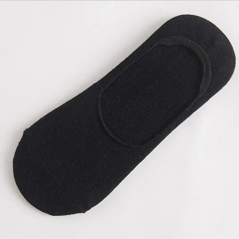 Single piece of solid black mens invisible slipper sock designed for running and casual shoes