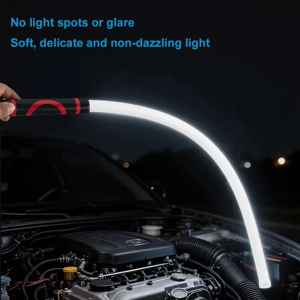 Person using a white LED light bar to inspect a car engine at night.