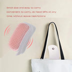 Small device with a brush-like head and carrying bag on a beige background