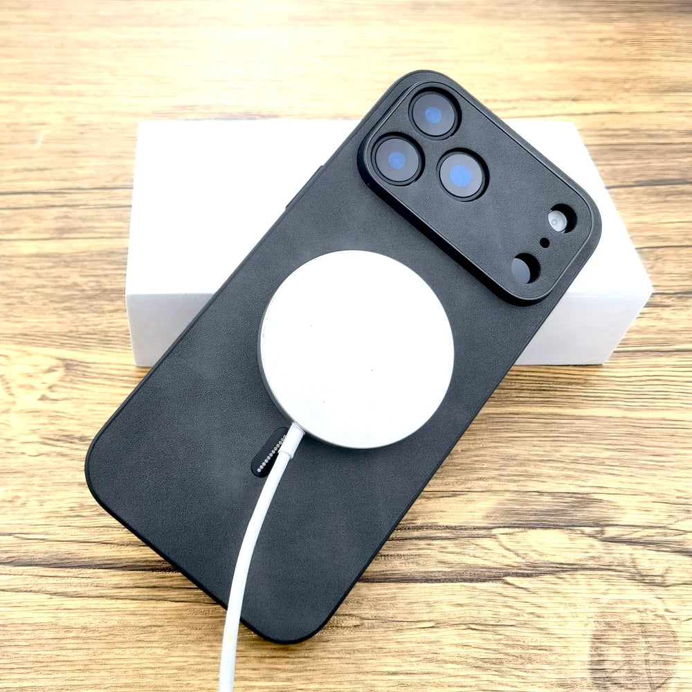 Black phone case with a white charging pad on a wooden surface