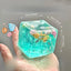 blue ocean squishy stress balls cube resting on desk displaying water clear ice texture and charm