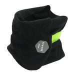 Black travel pillow with a green accent on a white background