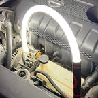 Car engine with a LED light illuminating the area, brand logo visible