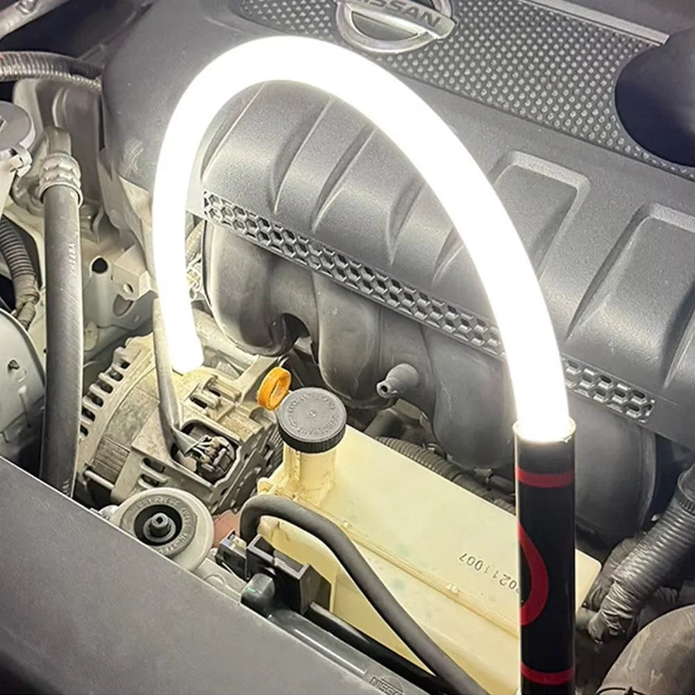 Car engine with a LED light illuminating the area, brand logo visible