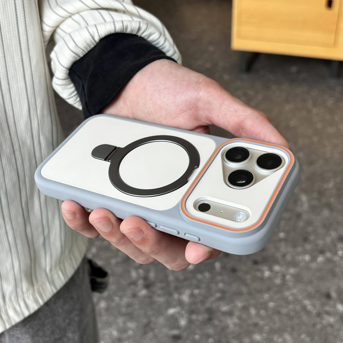 Person holding a phone case with a unique design
