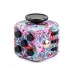 Colorful fidget cube with floral pattern on a white background