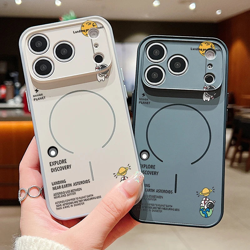 Two phone cases with space-themed designs held by a hand in a kitchen setting.