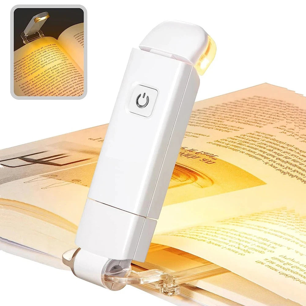 clip on reading light attached to open book emitting warm amber glow for eye protection late night reading