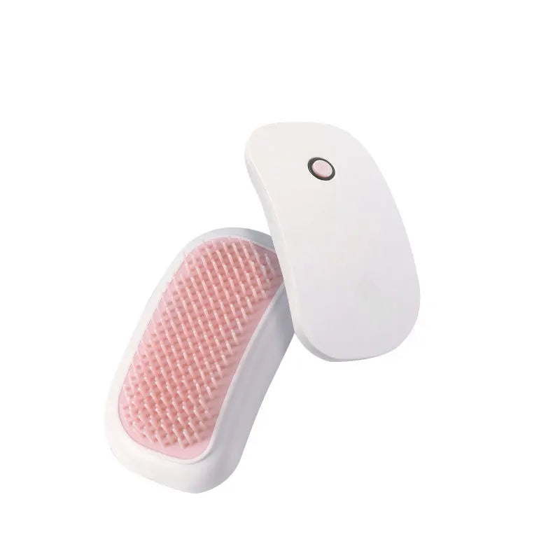 White and pink grooming brush on a white background