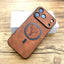 Brown phone case with deer design on a wooden surface