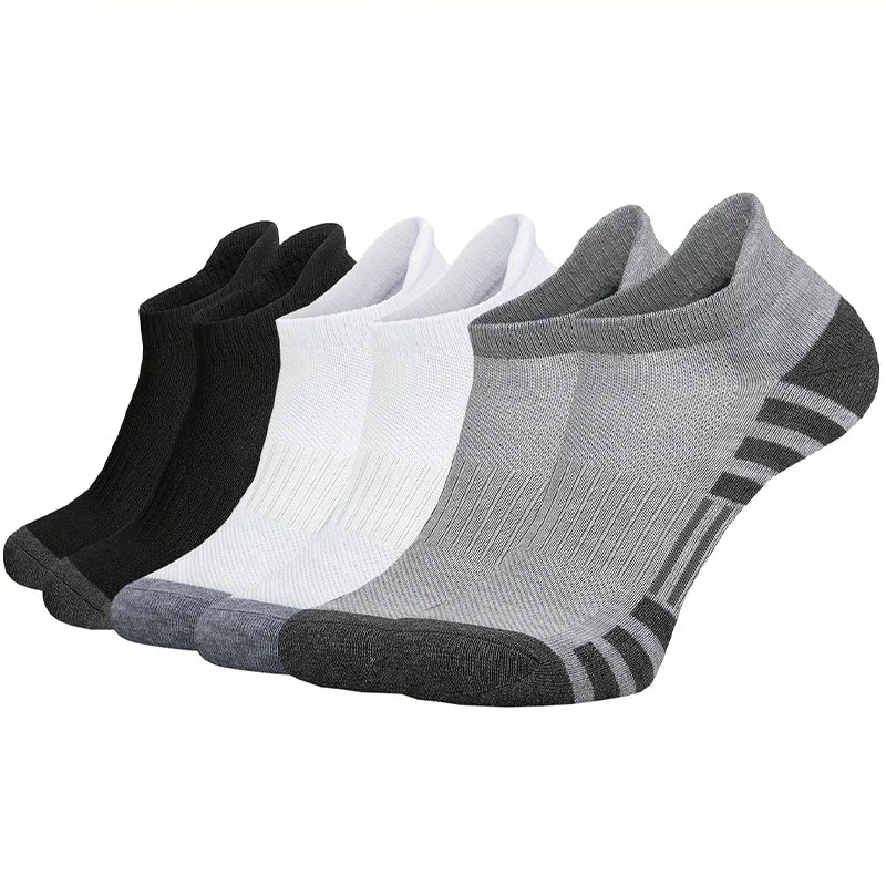 Three pairs of men's low cut breathable sports socks displaying black, white, and grey variants together.