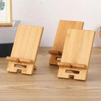 adjustable wooden phone stand showing natural wood finish and adjustable slot grooves for desk use