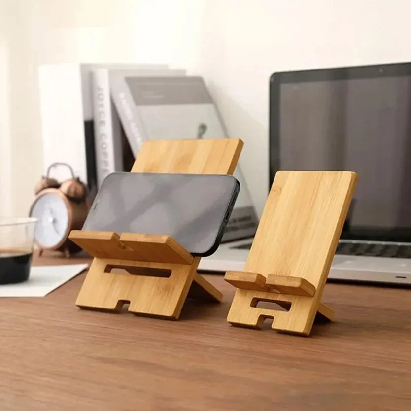 adjustable wooden phone stand placed on office desk next to keyboard for hands free mobile viewing