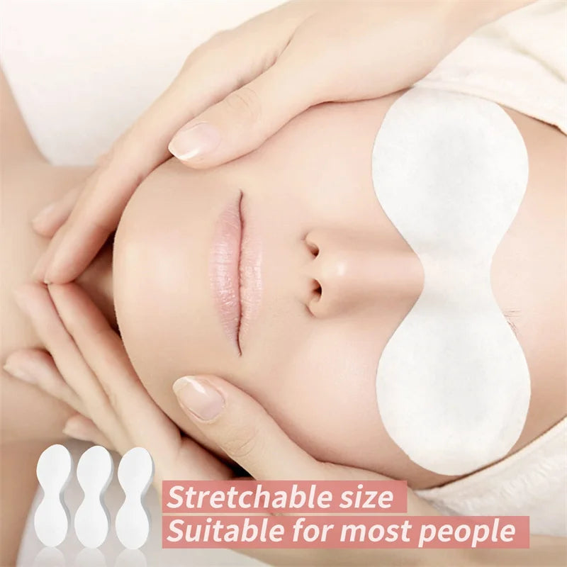 disposable eye mask paper used on model during relaxing facial spa treatment for eye skin hydration