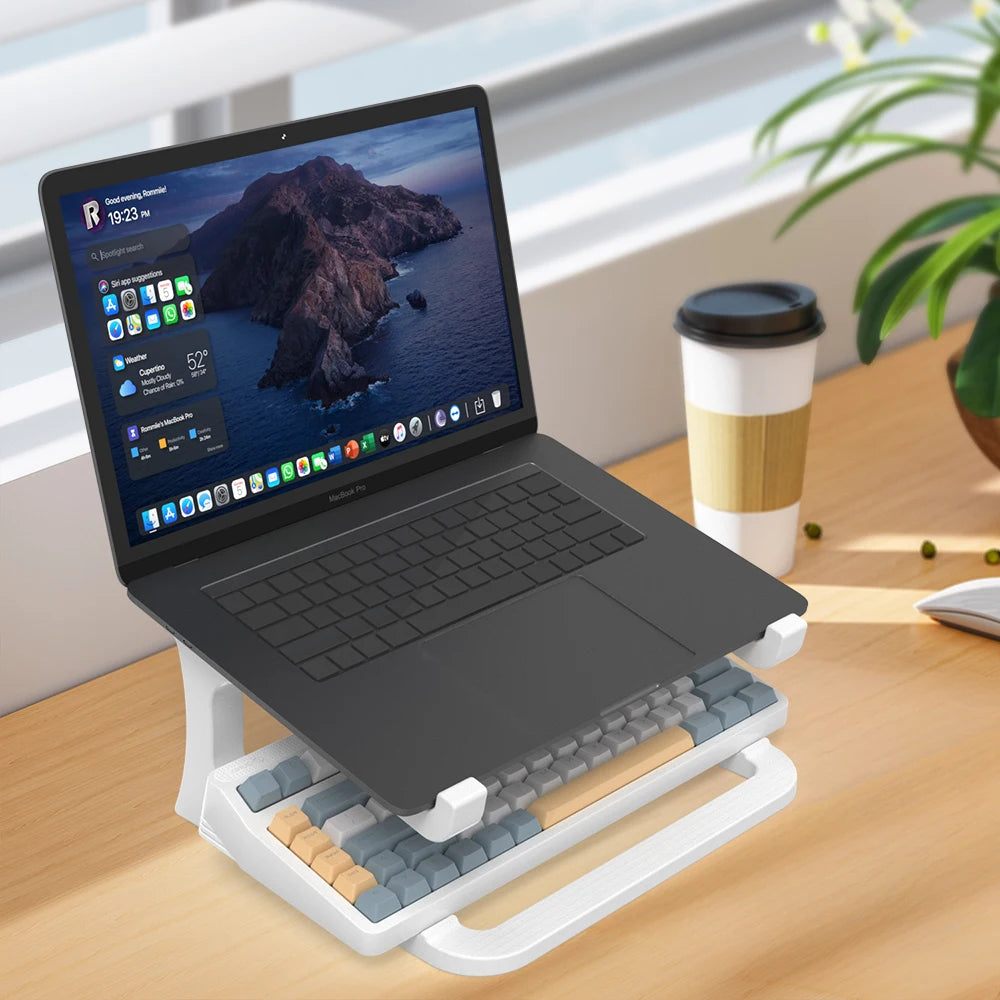 Ergonomic desktop laptop lift elevating MacBook screen for comfortable typing posture