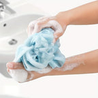 exfoliating bath towel set mesh loofah ball held in hand creating rich foam for gentle body cleansing
