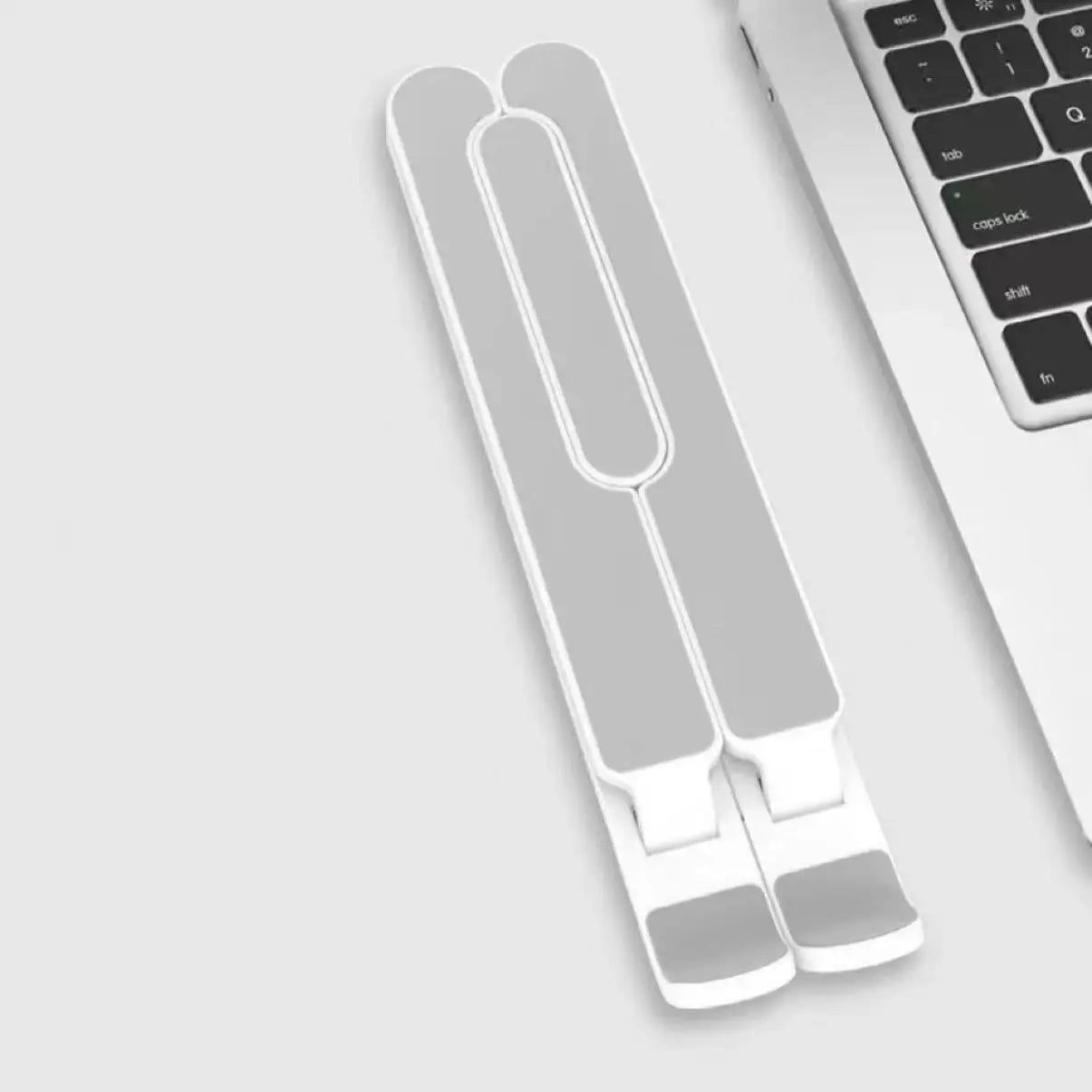 Lightweight foldable laptop stand in flat folded state