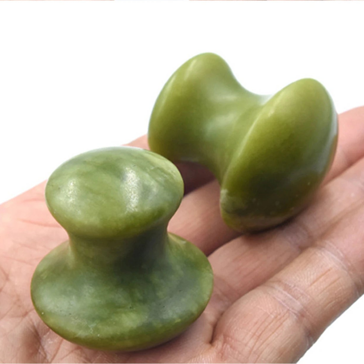 green quartz facial roller mushroom massage stone held in hand for under eye treatment and neck care