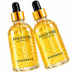 Two clear glass dropper bottles filled with golden hyaluronic acid serum, labeled 'GOLD FOIL' and 'HYALURONIC ACID' with Chinese text near the bottom, shown on a white background.