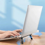Invisible laptop stand in use while typing on a notebook cooling riser
