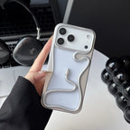 Phone case with snake design held by a hand on a desk