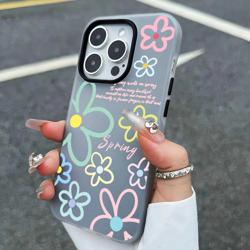 Phone case with colorful floral designs held by a person.
