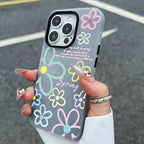Phone case with colorful floral designs held by a person.