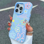 Blue phone case with floral designs held by a hand against a dark background