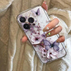 Phone case with floral and butterfly design held by a hand