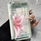Phone case with a pink flower design held by a hand on a light surface