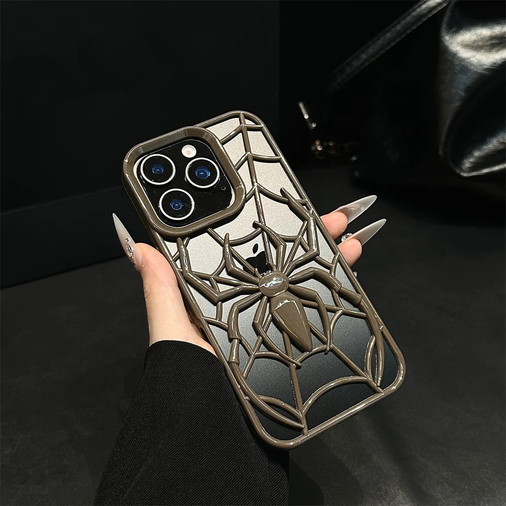 Phone case with spider design held by a hand against a dark background