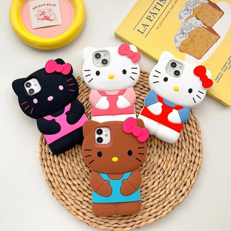 Four Hello Kitty phone cases in different colors on a woven mat.