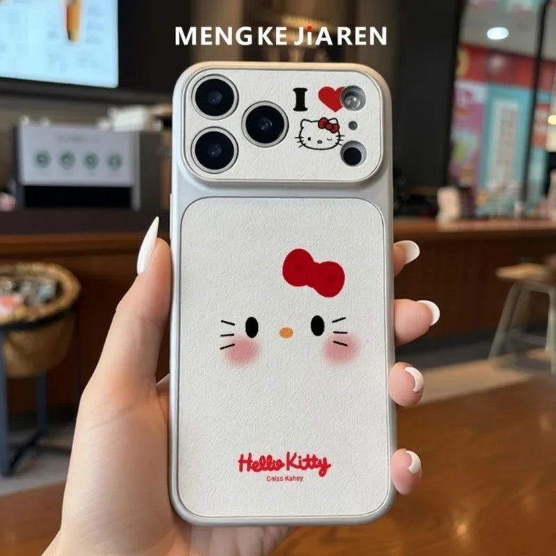 A hand holding a white Hello Kitty phone case with a red bow and face, featuring a camera cutout and a small 'I <heart> Hello Kitty' design on the upper back. The background is a blurred indoor setting with the text 'MENGKEJIAREN' at the top.