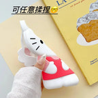 Phone case with cartoon design held by a hand on a yellow surface