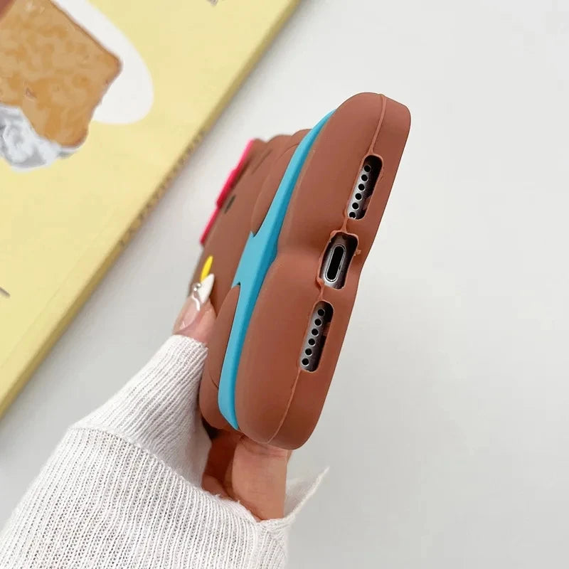 Phone case with brown back and blue edge held by a person wearing a white sweater.