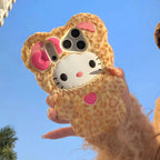 Phone case with a cartoon character design held against a blue sky.