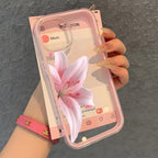 Phone case with pink floral design held by a hand against a gray background