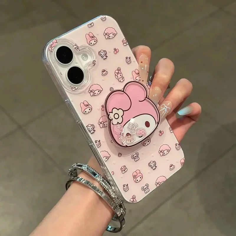 A hand holding a clear phone case decorated with a pink and white My Melody cartoon pattern, featuring a matching pink 3D stand on the back.
