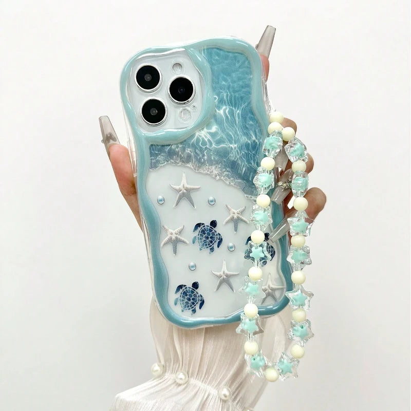 Light mint blue turtle iPhone cover showing wavy edge frame and decorative bead string accessory