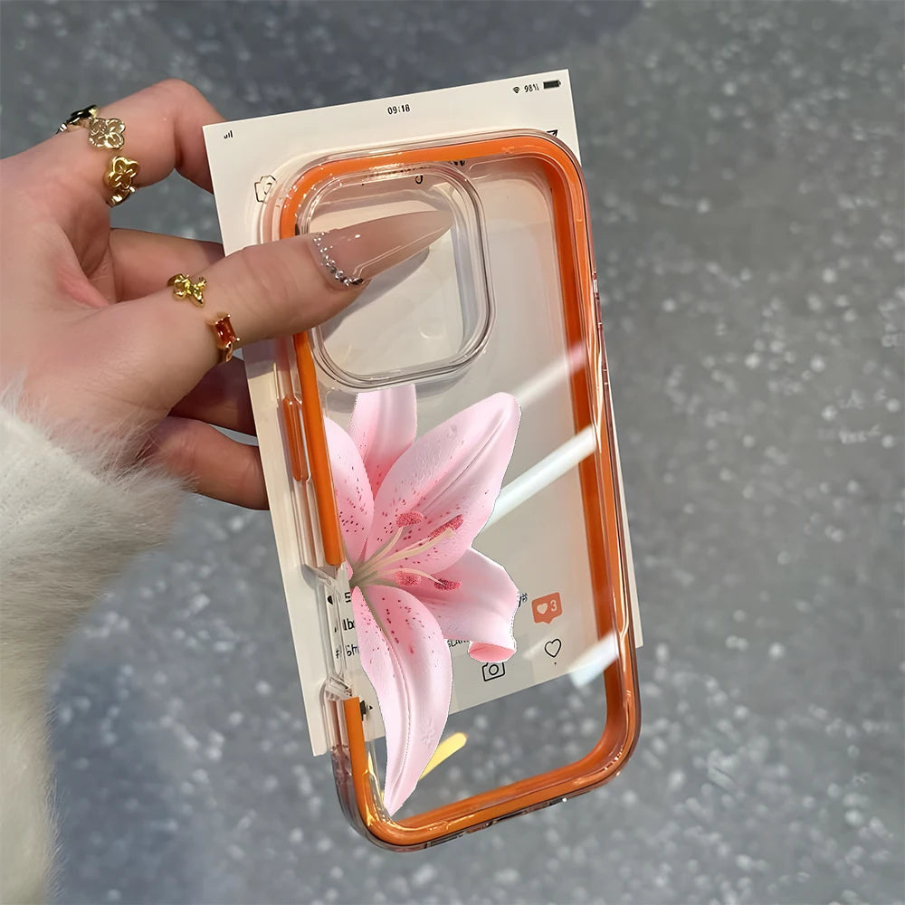 Phone case with pink flower design held by a hand against a gray background