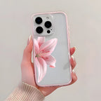 Phone case with pink flower design held by a hand against a light background